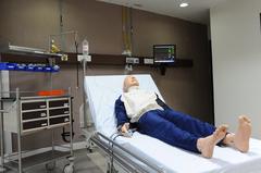 Modern simulation lab with multiple computer monitors and medical equipment for training