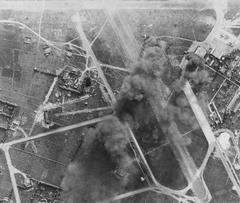 Japanese aircraft and installations burning at Tan Son Nhut airfield near Saigon during USS WASP airstrikes on 12 January 1945
