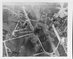 Japanese aircraft and facilities burning at Tan Son Nhut airfield in Saigon during U.S. Navy attack from USS Wasp on 12 January 1945