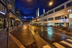 Fredrikinkatu street in Helsinki illuminated at night with streetlights and buildings
