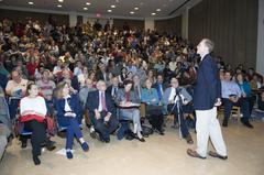 Dr. John Mather addressing a packed auditorium in the Physics Department at University of Maryland discussing his Nobel Prize-winning work on the Cosmic Background Explorer (COBE)
