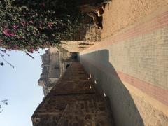 Scenic path leading to Golconda Fort with stone steps and ancient walls under clear sky
