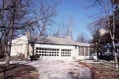 Three car garage built of white limestone attached to White Haven historic site