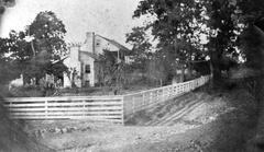 Black and white photo of White Haven, a two-story frame house surrounded by white rail fence