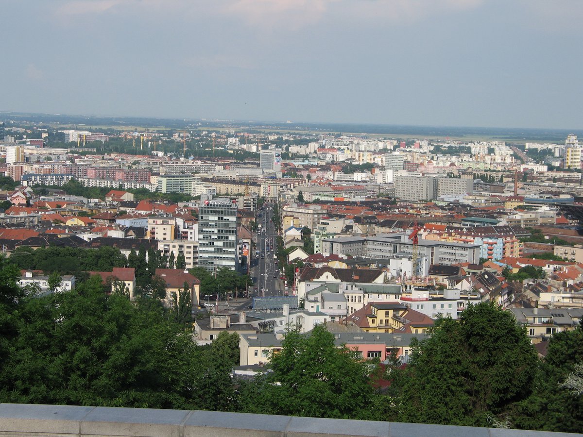 View of Bratislava's Šancová Street ending at Račianske Mýto with the prominent Dom odborov building in the background