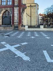 28 white crosses embedded in cobblestones at Old Town Square in Prague commemorating the 1621 execution of Czech nobles