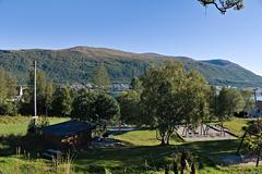 Children playing at Fagerdal playground in Tromsø with colorful play structures and autumn foliage