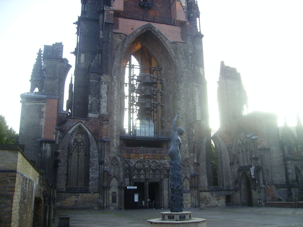 Ruins of St. Nikolai Church in Hamburg with scaffolding and surrounding memorial area
