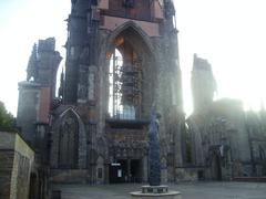 Ruins of St. Nikolai Church in Hamburg with scaffolding and surrounding memorial area