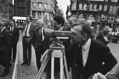 Dutch State Secretary Scherpenhuizen looking through a meter at the NAP benchmark in Amsterdam on January 21, 1986