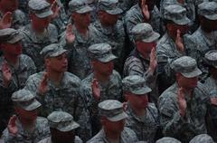 Soldiers, Sailors, Airmen and Marines raising right hands and reciting Oath of Enlistment during large re-enlistment ceremony at Al Faw Palace, Camp Victory
