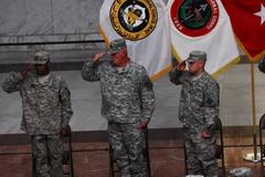 Soldiers saluting the entrance of the colors at Army National Guard's 372nd Birthday Ceremony in al Faw Palace Baghdad Iraq