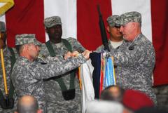 Lt. Gen. Charles H. Jacoby and Command Sgt. Maj. Frank Grippe uncase 1st Corps colors during transfer of command ceremony at Al Faw Palace, Camp Victory, Iraq, April 2009
