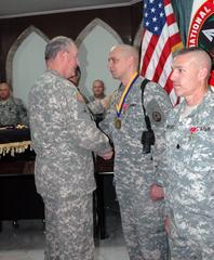 Maj. Gen. James E. Simmons presenting the Order of St. Michael Medallion to Maj. Allen G. Hahn at Al Faw Palace, Camp Victory, Iraq