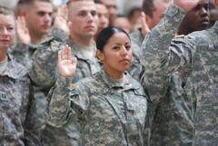 Pfc. Estela Calvillo reciting oath of citizenship at naturalization ceremony at Camp Victory