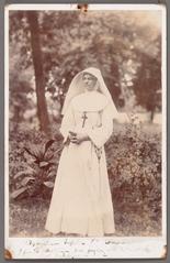 Dymphna Gezelle standing in a garden holding a breviary