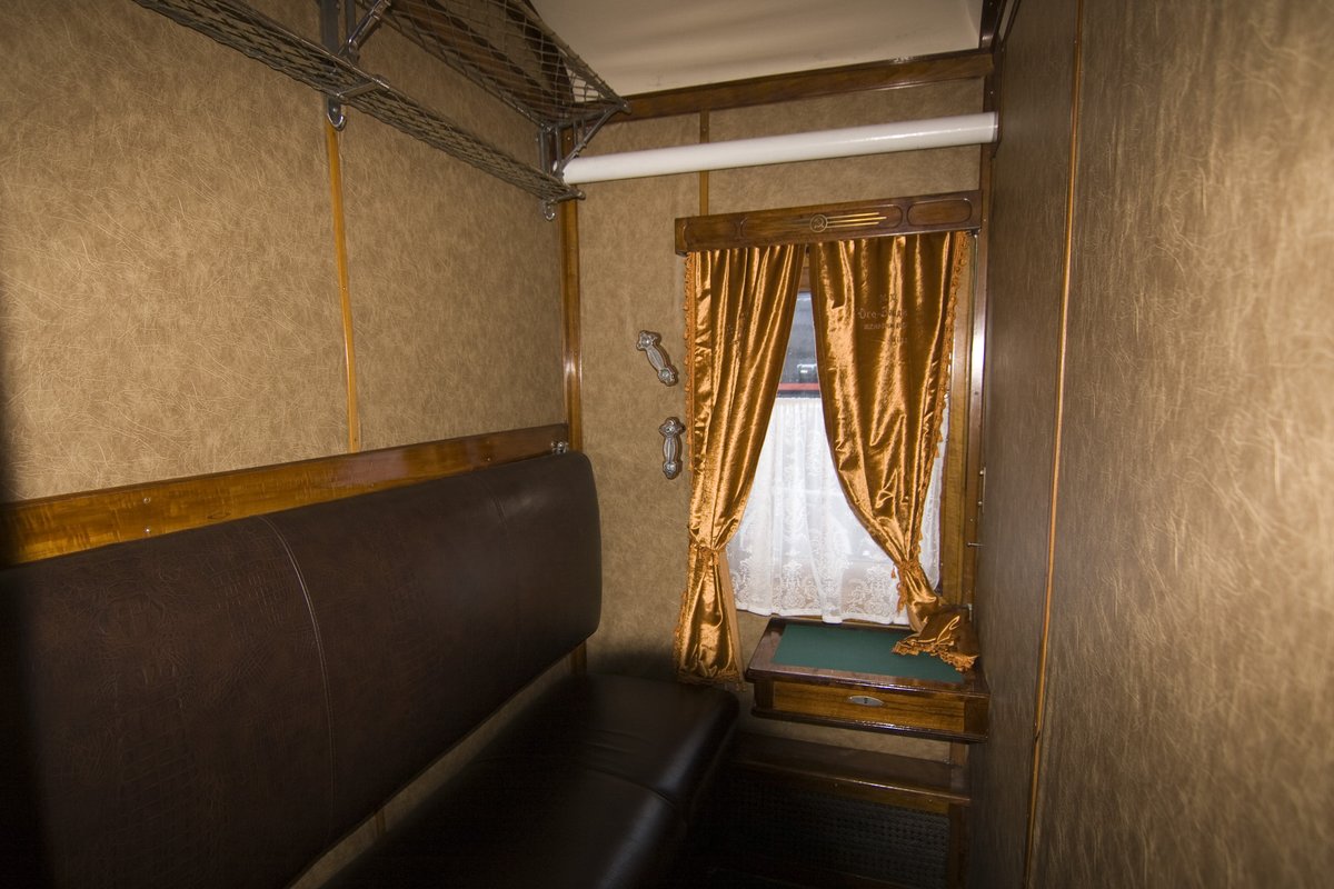 Interior of a vintage train carriage at a historical railway exhibition in Kyiv