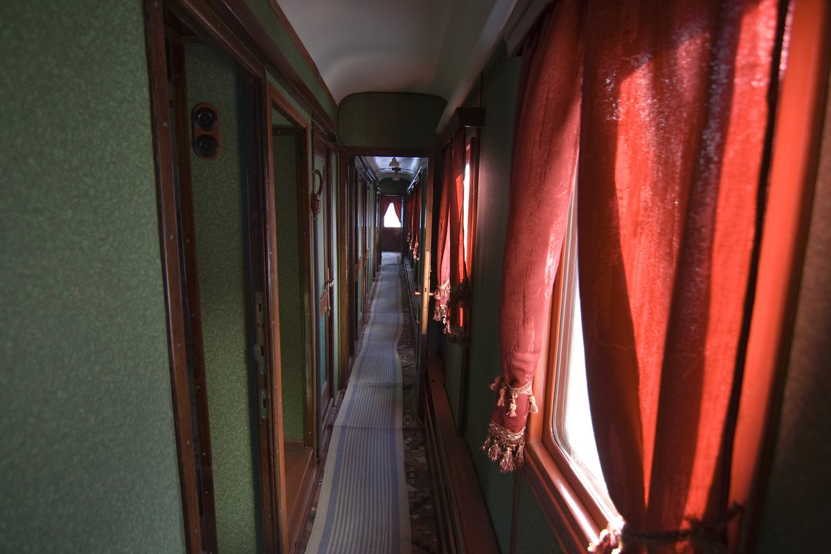 Interior of a vintage train carriage at a historical railway exhibition in Kyiv with wooden seats and windows