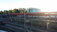 Gare de Geneve Secheron train station building with clock tower and rails