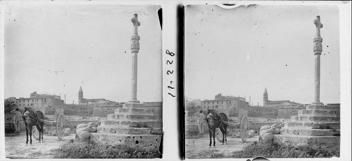 Historic wall cross and Socors bell tower in black and white photograph