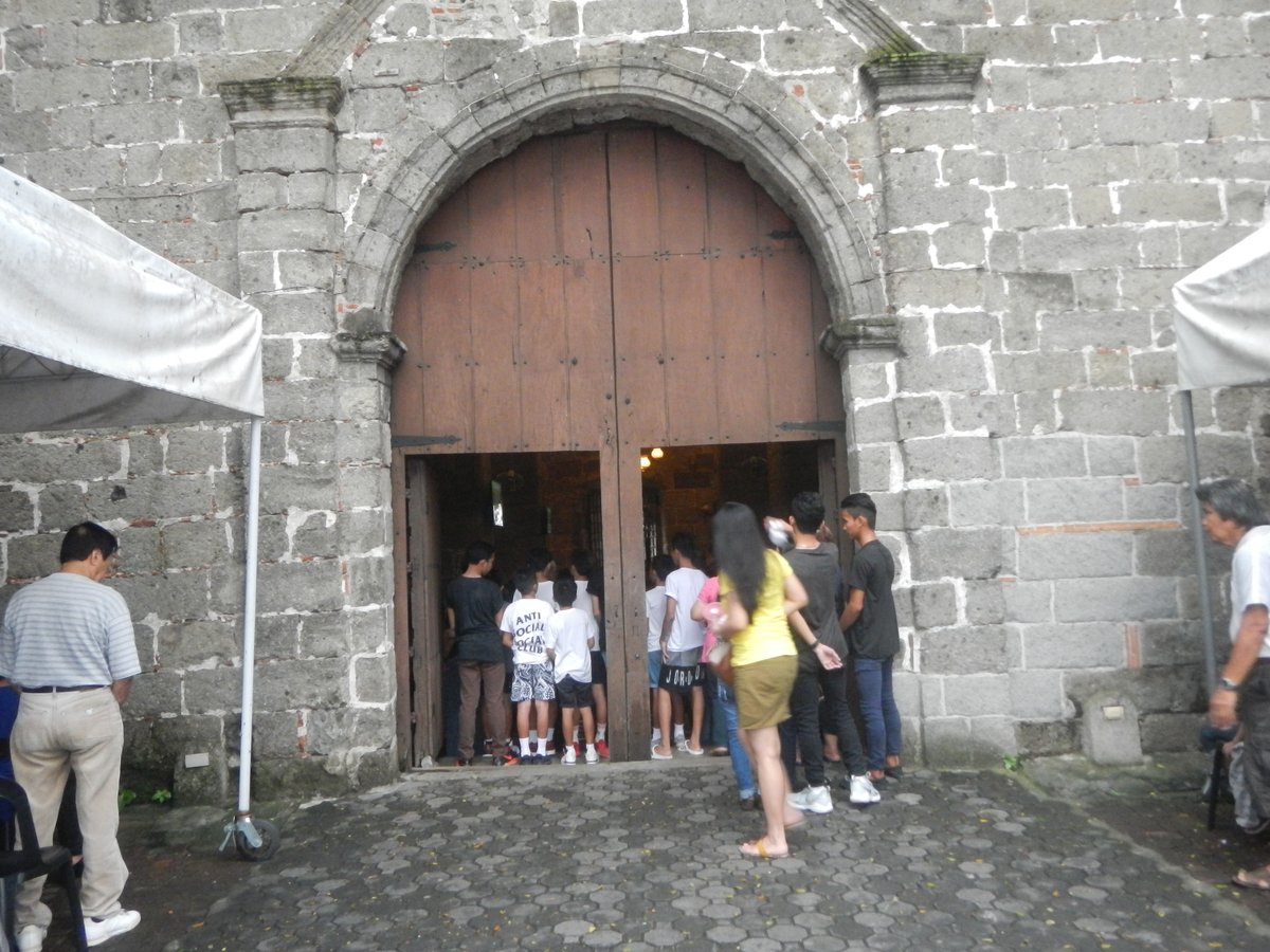 Interior view of Parokya ni San Jose Bamboo Organ Church showing wooden arches and bamboo organ pipes