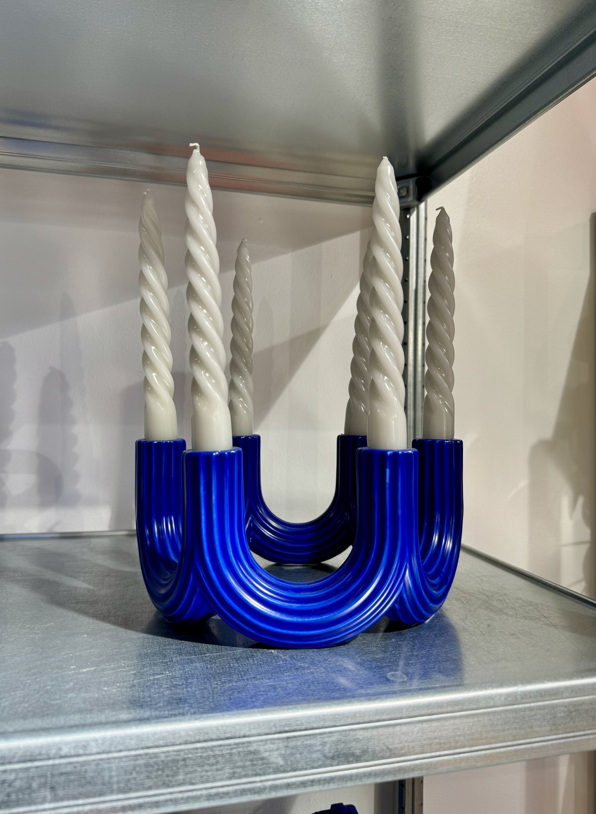Blue churros shaped candle holder made of aluminium