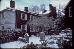 Historic Gloria Dei Old Swedes' Church in Philadelphia with lush green lawn and autumn trees