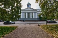 Helsinki Old Church exterior with green lawn and blue sky