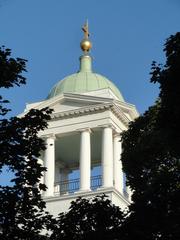Helsinki Old Church exterior with green lawn and blue sky