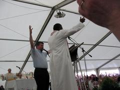 Large crowd with raised hands praying and celebrating at a charismatic prayer meeting in Slovenia