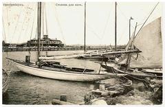 Yachts docked at Oranienbaum yacht stop on a calm water body
