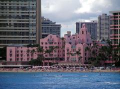 Royal Hawaiian Hotel viewed from the sea with palm trees in front