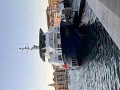 Bateau Edmond Dantes docked at Vieux-Port de Marseille with city buildings in background