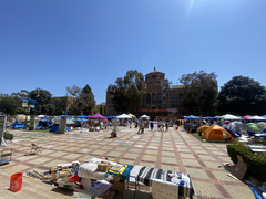 UCLA Pro-Palestinian encampment with tents set up on the lawn, view towards Powell Library from Royce Hall