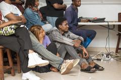 Youth captivated by the theatrical show 'Tant qu'on s'aime' at Institut Français in Goma