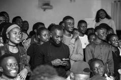 Young captivated audience watching a show at Institut Français in Goma
