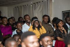 Youth enjoying a theatrical performance 'Tant qu'on s'aime' at Institut Français in Goma