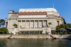 The Fullerton Hotel Singapore illuminated at night with reflections in water