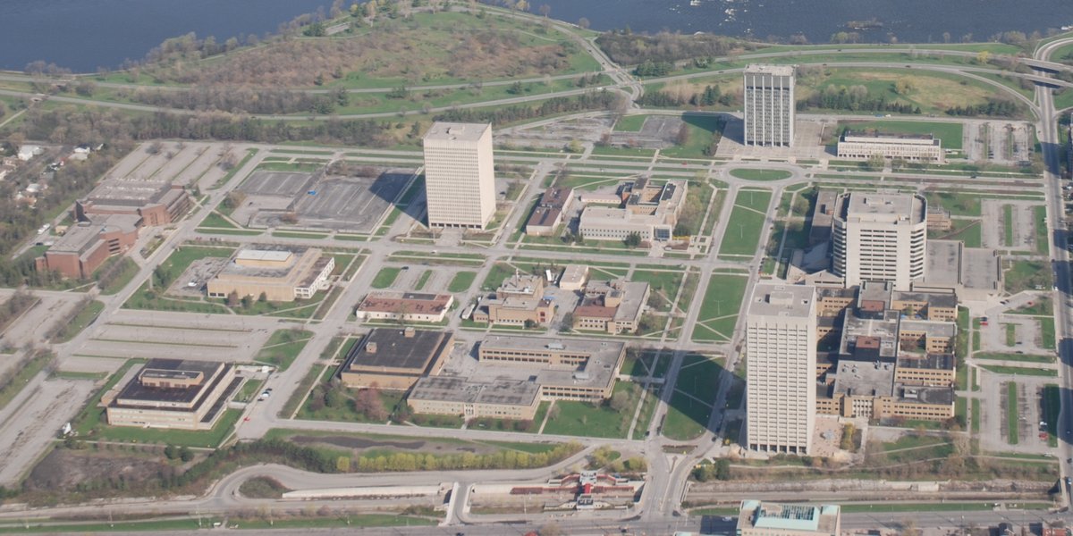 Aerial view of Tunney's Pasture in Ottawa, Ontario, Canada showing buildings, roads including Parkdale Avenue and Transitway with Tunney's Pasture Station