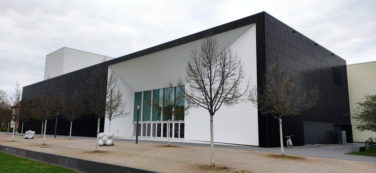 Modern hall complementing the restored castle in the music university ensemble