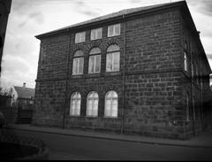 Exterior shot of the east side of Althingi parliament building in Iceland with broken windows after 1949 NATO membership riots
