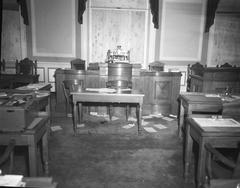 Interior of Althingi with barricaded windows and scattered papers after 1949 rioting