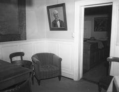 Interior of Althingi Icelandic parliament with broken glass on floor and framed picture shattered