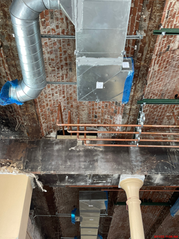 Duct work and copper pipe running along brick ceiling in Old Courthouse renovation