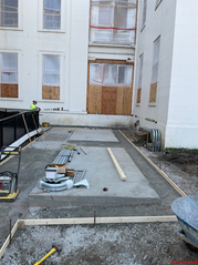 Concrete pads for chillers in front of Old Courthouse with boarded-up windows during HVAC renovation