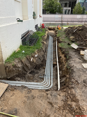 Electrical conduit being installed in a trench along the west side of the Old Courthouse during HVAC renovation