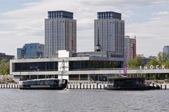 Moscow South River Terminal building and quay with moored boats on a river