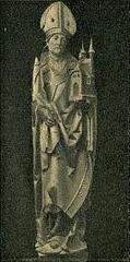 Statue of Saint Iwo Odrowąż in traditional religious attire holding a cross and a book