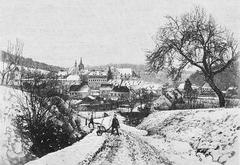Winter scene of Bebenhausen with snow-covered buildings and trees