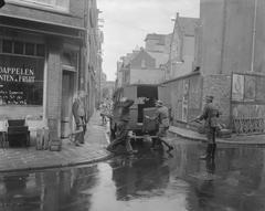 1958 film shoot scene in Amsterdam's Staalstraat showing grocer D. van Hoeven being taken away during Anne Frank movie production
